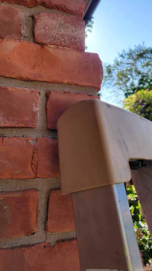 Leaning Ladder Helmet on brick side angle